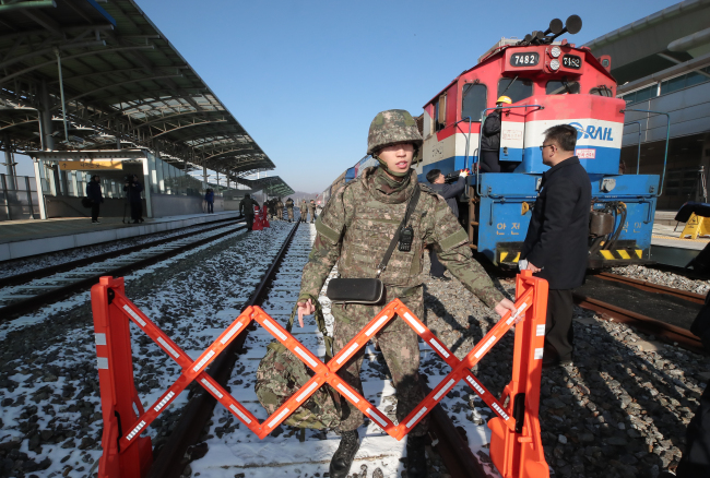 A South Korean soldier inspects the train that was used for the two Koreas' joint inspection of cross-border railways, as it enters Dorasan Station near the inter-Korean border on Dec. 18. (Yonhap)