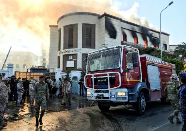 A firetruck and security officers at the scene of an attack on the Libyan foreign ministry in Tripoli on December 25, 2018. (AFP)