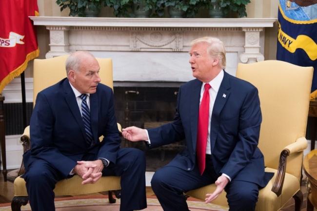 Outgoing White House Chief of Staff John Kelly, pictured with President Donald Trump in July 2017, told the Los Angeles Times that many migrants have been misled by traffickers. (AFP)
