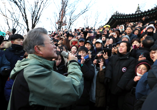 President Moon Jae-in addresses the people gathered to see the sunrise on Namsan in Seoul on Tuesday. Cheong Wa Dae