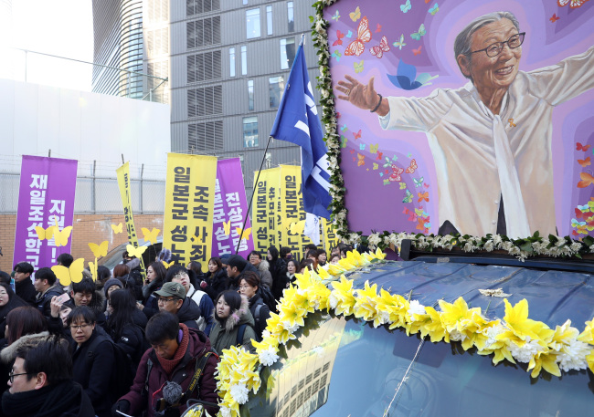 Funeral procession of Kim Bok-dong passes the site of the old Japanese embassy in Seoul on Friday. Yonhap