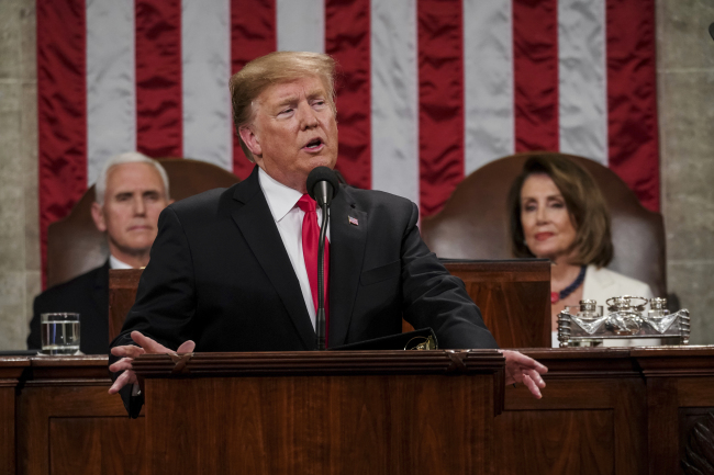 President Donald Trump gives his State of the Union address to a joint session of Congress, Tuesday, Feb. 5, 2019 at the Capitol in Washington, as Vice President Mike Pence, left, and House Speaker Nancy Pelosi look on. (Doug Mills/The New York Times via AP, Pool)