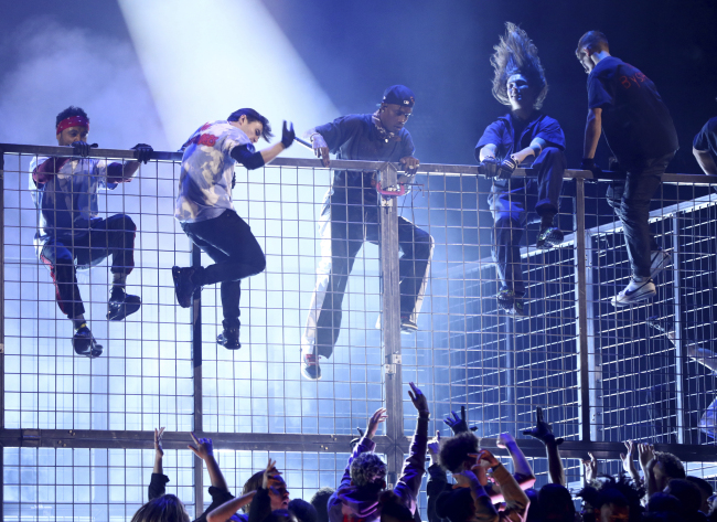 Travis Scott, center, climbs a cage during a performance at the 61st annual Grammy Awards on Sunday, Feb. 10, 2019, in Los Angeles. (AP)