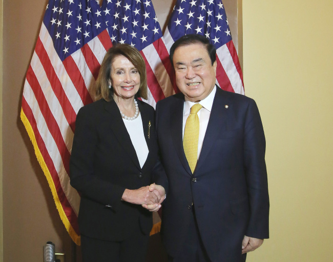 National Assembly Speaker Moon Hee-sang (right) shakes hands with US House Speaker Nancy Pelosi during their meeting in Washington on Tuesday. Yonhap