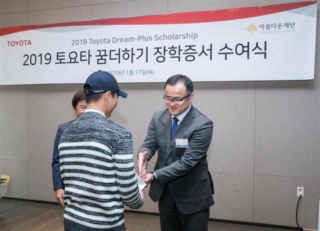 다케무라 노부유키 한국 토요타 자동차 사장이 지난 1월 17일 서울 마포 스탠포드 호텔에서 열린 ‘토요타 꿈 더하기’ 장학증서 수여식에서 한 학생에게 장학금을 수여하고 있다.