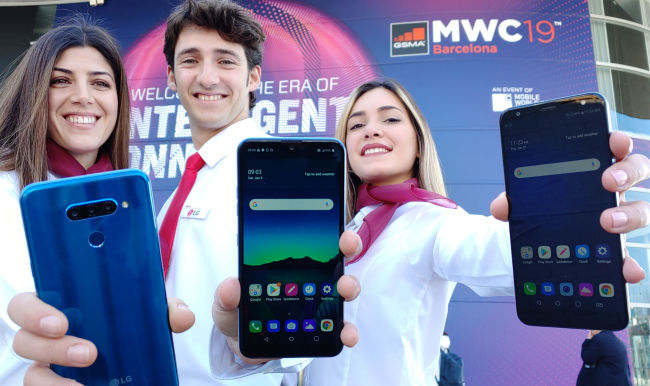 LG Electronics' employees present new LG Q60 (from left), LG K50, and LG K40, which will be showcased at the MWC 2019 being held in Barcelona, Spain, this week, along with its new 5G smartphone. (Yonhap)