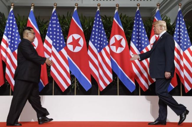 This June 12, 2018, file photo, U. S. President Donald Trump and North Korea leader Kim Jong Un walks toward each other at the Capella resort on Sentosa Island in Singapore. Trump and Kim will likely be all smiles as they shake hands later this week in Hanoi for a meeting meant to put flesh on what many critics call their frustratingly vague first summit in Singapore. But behind the grins is a swirl of competing goals and fears. (AP Photo/Evan Vucci, File)