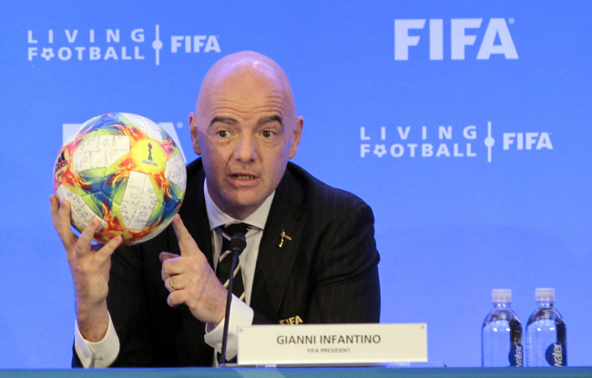 FIFA President Gianni Infantino holds a soccer ball as he speaks during a press conference after the FIFA Council Meeting, Friday, March 15, 2019, in Miami.(AP)