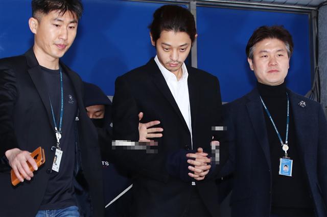 성관계 동영상을 불법적으로 촬영·유포한 혐의로 구속된 가수 정준영이 29일 오전 서울 종로경찰서 유치장에서 나와 검찰로 송치되고 있다. 정준영은 ‘왜 증거인멸을 시도했느냐’ 등 취재진의 질문에 일절 답하지 않고 곧장 호송차에 올라탔다.  [연합]