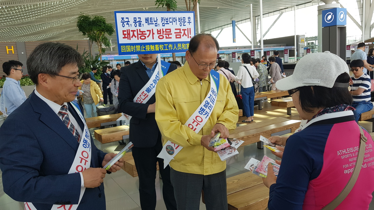 김태환 농협축산경제대표이사가 15일 남태헌 농림축산검역본부 인천공항지역본부장(왼쪽)과 함께 시민들에게 ASF 국내 유입방지 홍보 전단지를 나눠주며 캠페인을 벌이고 있다. [농협 제공]