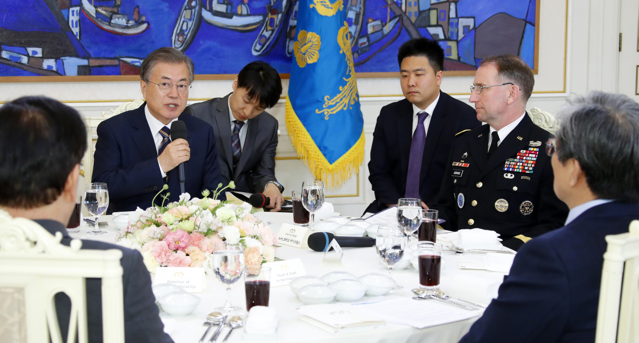President Moon Jae-in speaks during a meeting with senior US and South Korean military commanders, including Gen. Robert Abrams (right), chief of the US Forces Korea, at the presidential office on Tuesday. Yonhap