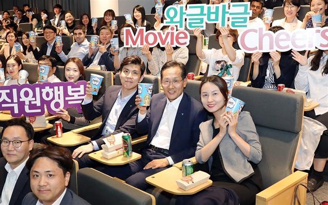 KEB하나은행은 28일 저녁 을지로 신축본점 대강당에서 직원들의 행복과 소통을 위한 시네마 데이 행사 ‘와글바글 무비 치어스’를 열었다. 지성규 하나은행장(앞에서 두번째 줄 오른쪽에서 두번째)이 직원들과 함께 팝콘을 들고 기념촬영을 했다.  [KEB하나은행 제공]