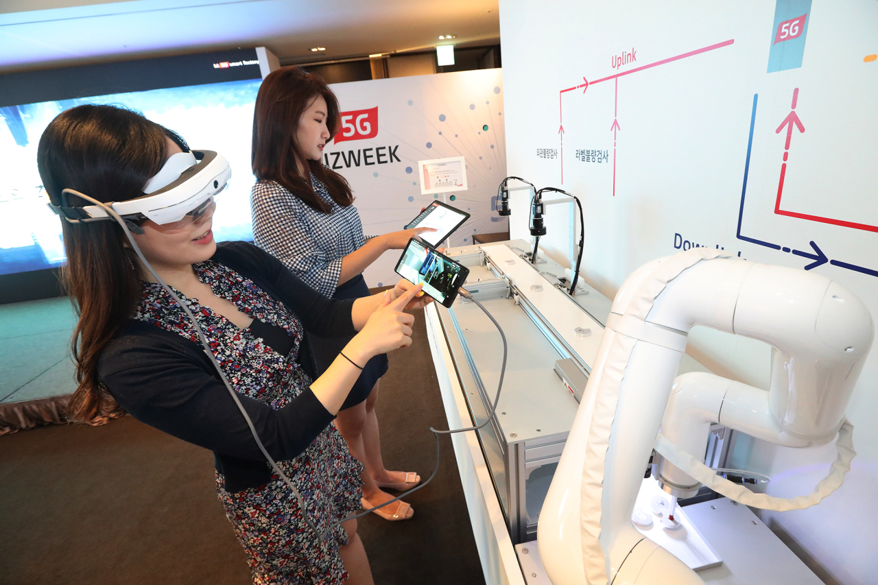 KT officials demonstrates how smart factory works during an event held in Seoul. KT