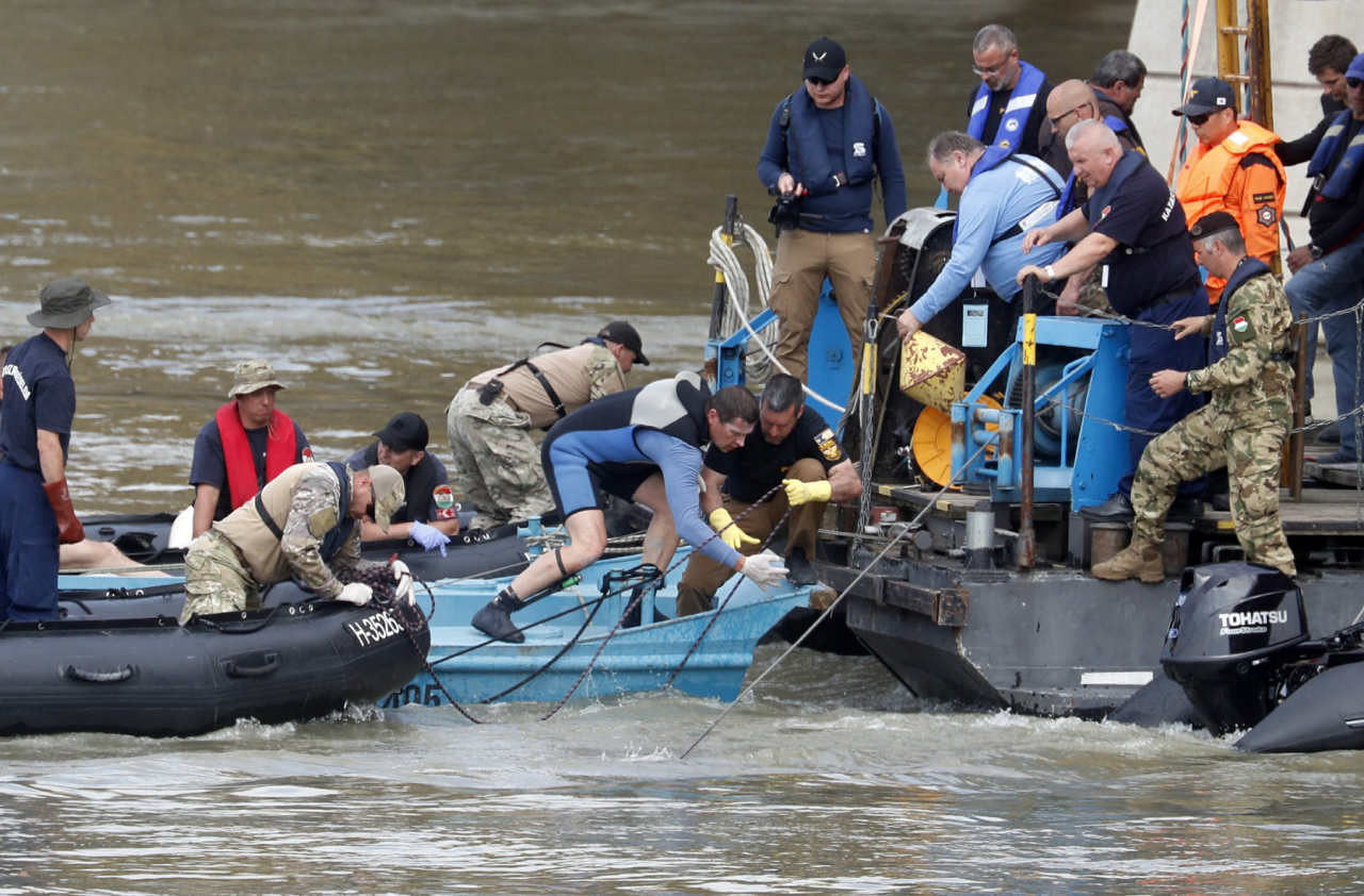 A rescue crew works on the Danube river where a sightseeing boat capsized in Budapest, Hungary, Tuesday, June 4, 2019. Divers recovered the bodies Monday of two more victims who were on a tour boat that capsized and sank in the Danube River after a collision with a river cruise ship. (AP Photo/Laszlo Balogh)