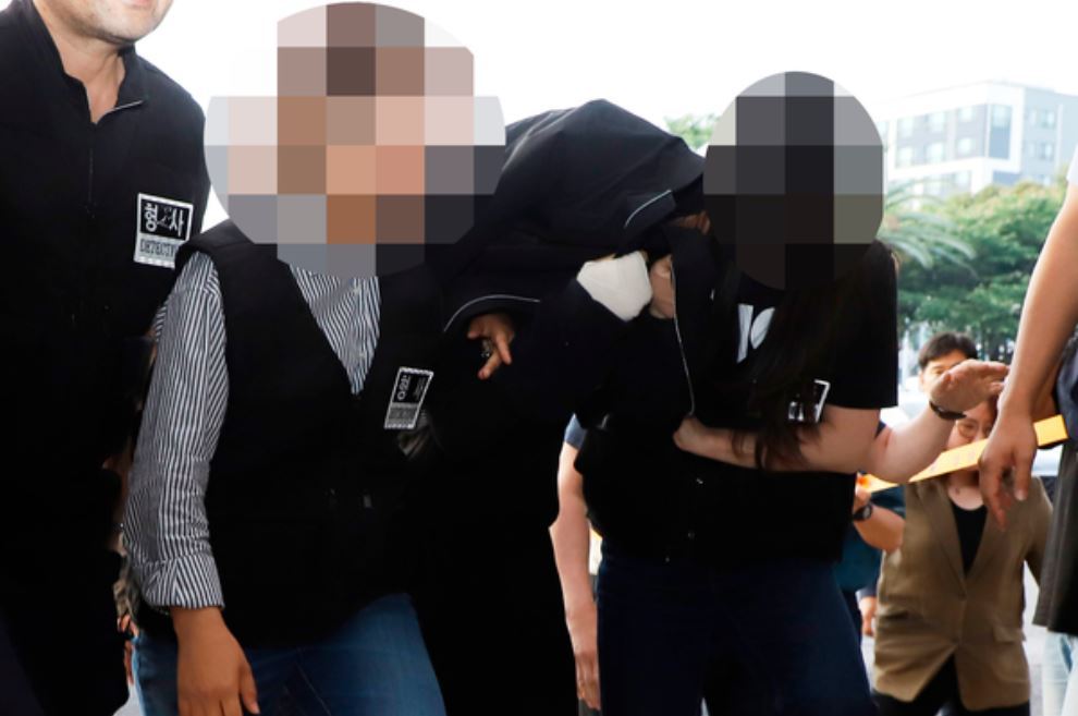 Police escort the suspect to Jeju Dongbu Police Station Saturday. (Yonhap)