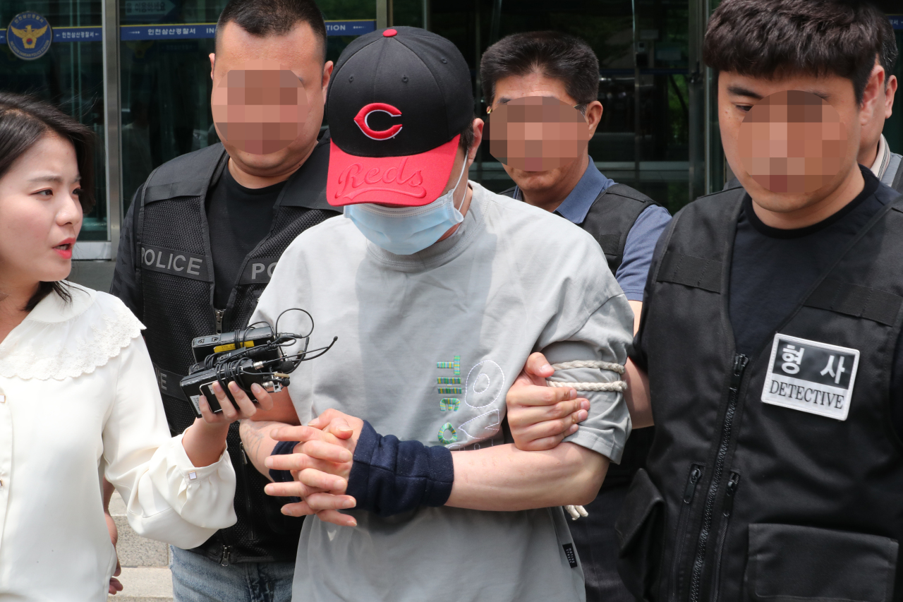 A man accused of stabbing his brother to death is seen leaving the Incheon Samsan Police Station for the Incheon District Court on Sunday. (Yonhap)