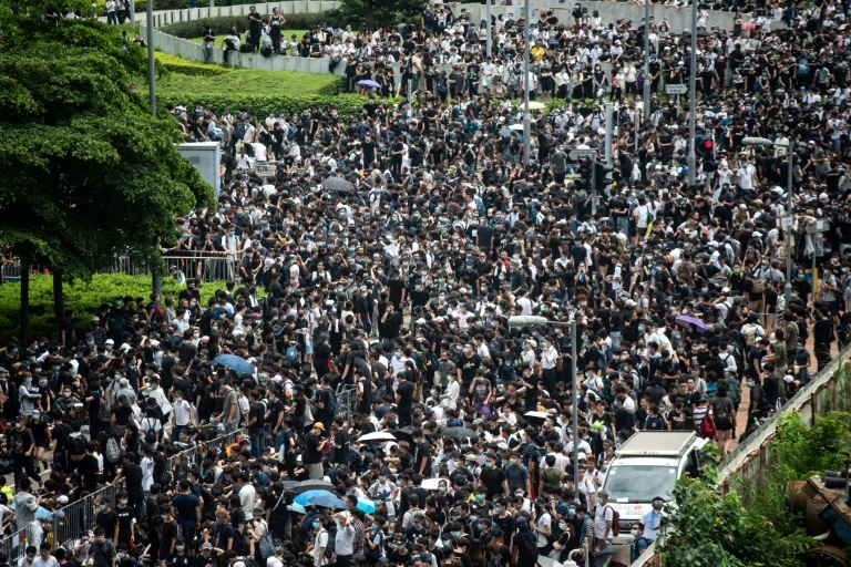 Protesters occupy the roads near Hong Kong's Legislative Council and government headquarters, forcing lawmakers to postpone a debate on the proposed extradition law (AFP)