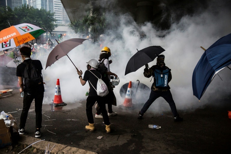 Tear gas fired by police surrounds protesters. (AFP)