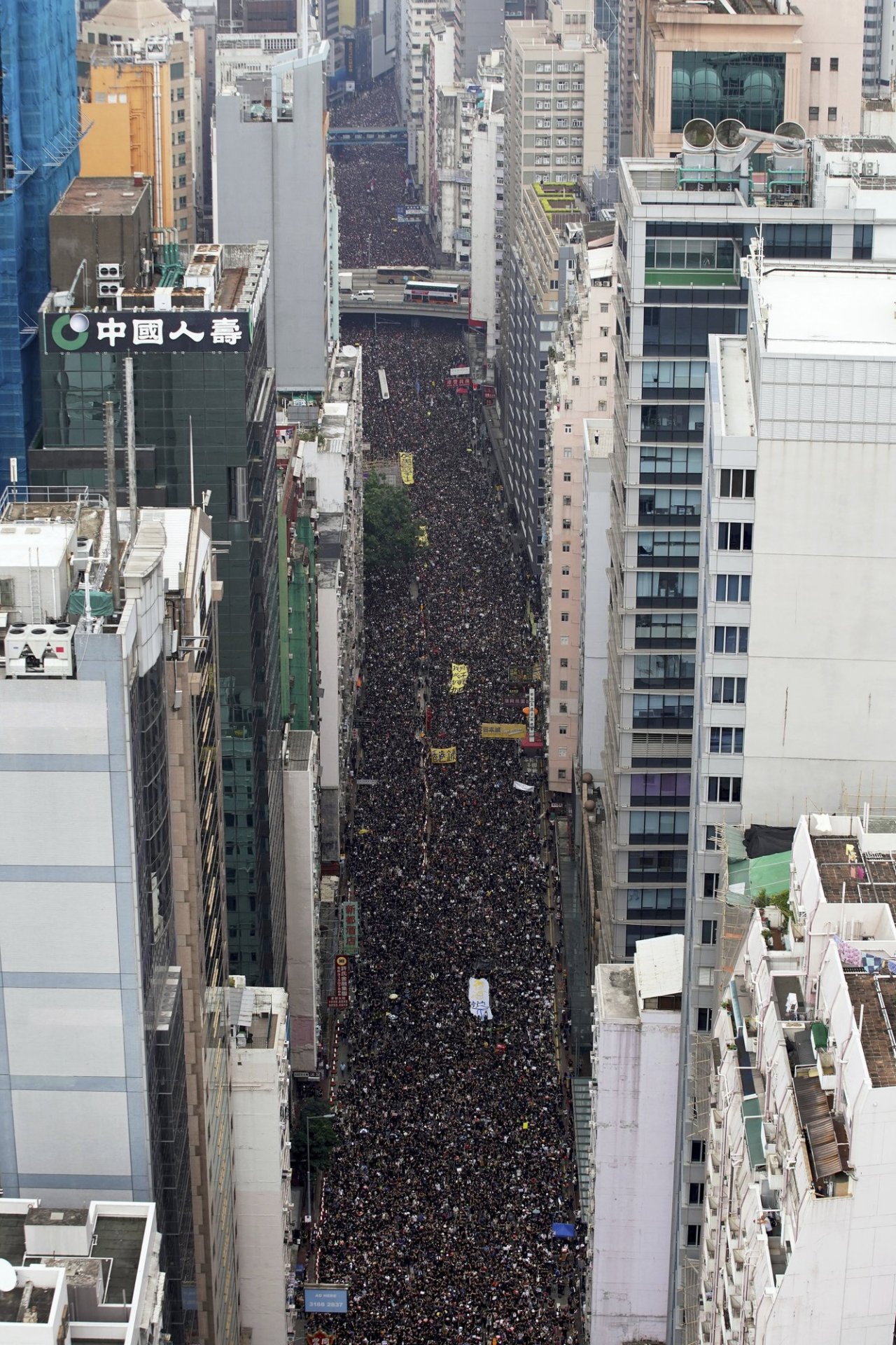 Tens of thousands of protesters carry posters and banners march through the streets as they continue to protest an extradition bill, Sunday, June 16, 2019, in Hong Kong. (AP)