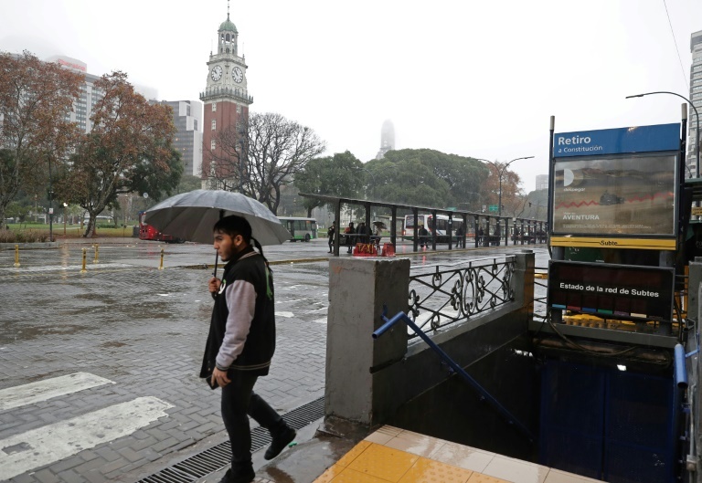 A man walks next to a closed subway station in downtown Buenos Aires during a power outage. (AFP)