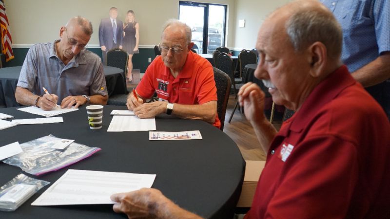Retirees Ronald McMahan (R), Don Eaton (C) and Andy Bilardello, all leaders of local Republican clubs, address envelopes inviting new residents to join the clubs in The Villages, Florida; all are supporters of US President Donald Trump. (AFP)