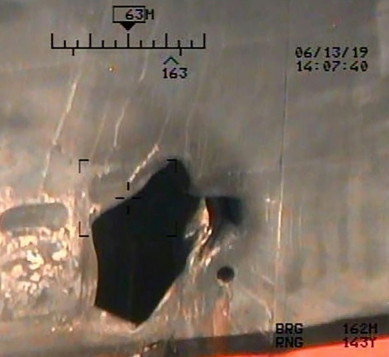 An image released by the US Department of Defense on July 17, 2019 shows damage from an alleged limpet mine attack on a tanker in the Gulf of Oman (AFP-Yonhap)