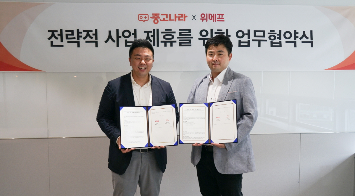 최정두 중고나라 플랫폼사업본부 본부장(오른쪽)과 김지훈 위메프 300실 실장이 4일 상품과 서비스를 공유하는 전략적 파트너십을 체결했다.[사진제공=중고나라]