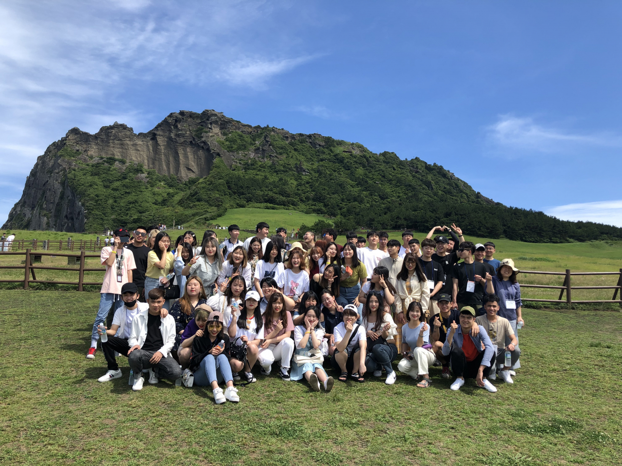 제주도 성산일출봉을 배경으로 기념촬영을 하고 있는 호산대 외국인 유학생들.[호산대 제공]