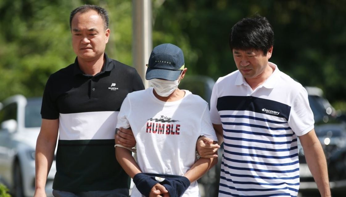 Police escort suspect to Gwangju District Court Monday. (Yonhap)