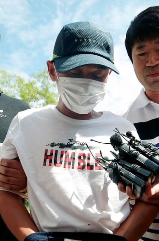 Police escort Kim to Gwangju District Court on Monday. (Yonhap)