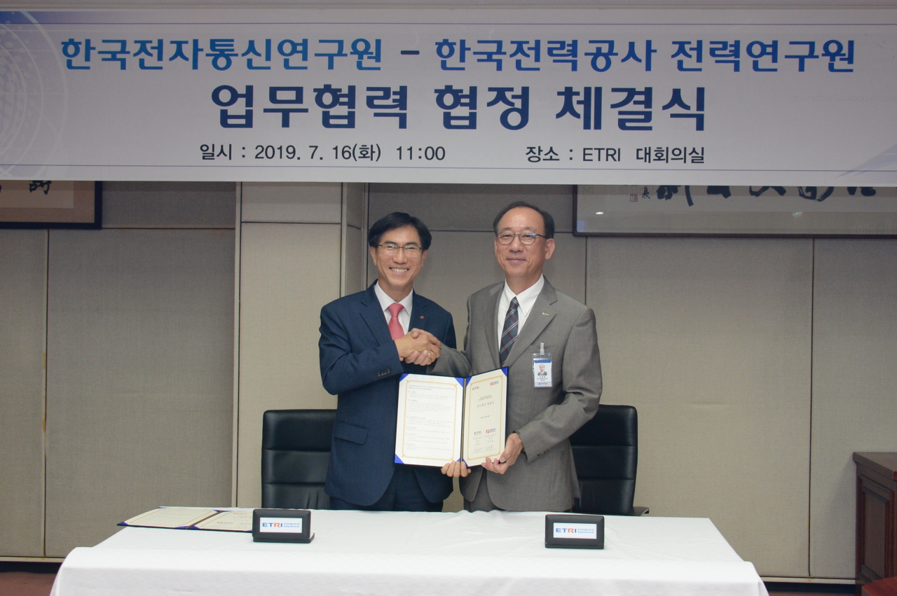 16일 열린 전력 및 ICT 분야 기술교류를 위한 업무협정식에서 김명준(오른쪽) 한국전자통신연구원 원장과 김숙철 한전 전력연구원 원장이 기념촬영을 하고 있다.[ETRI 제공]