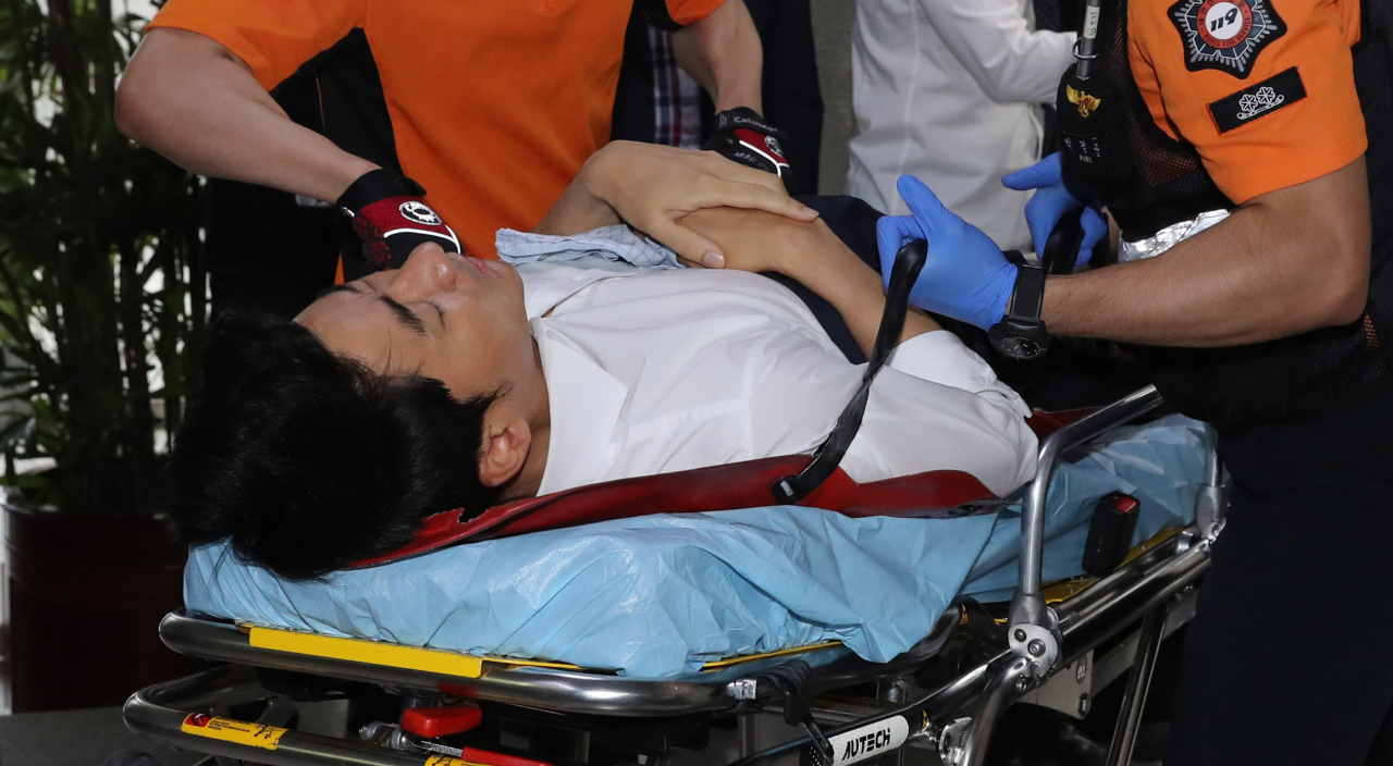 당 혁신 요구 단식 농성을 계속하던 권성주 바른미래당 혁신위원이 22일 오전 국회에서 최고위원회의를 마치고 이동하는 손학규 대표를 막아서다 넘어진 후 구급대원에 의해 이송되고 있다.[연합]