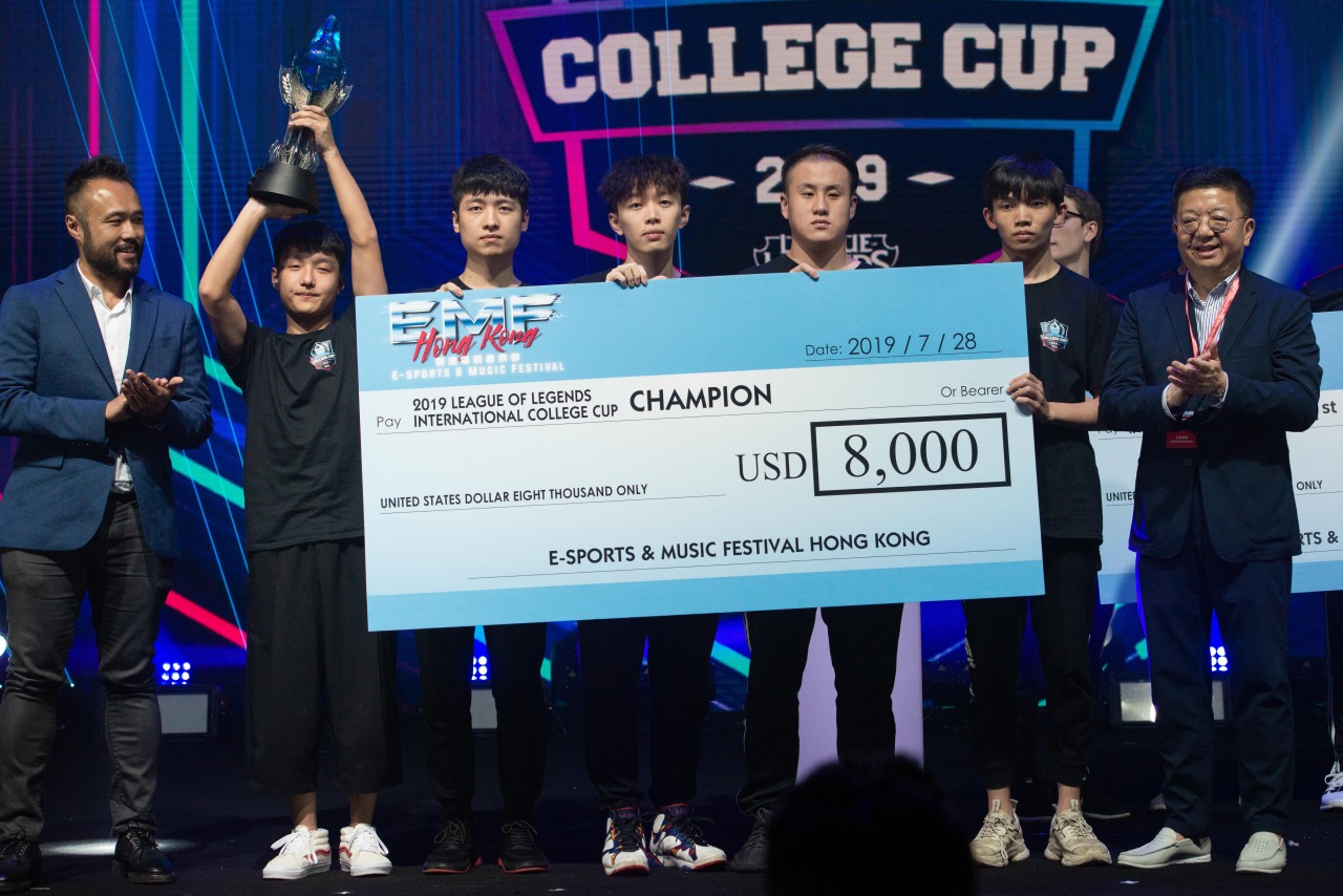 A player from Jimei University of China raises the winner‘s trophy while his teammates receive the money prize during the E-Sports and Music Festival Hong Kong 2019 on Sunday in Hong Kong. (Hong Kong Tourism Board)