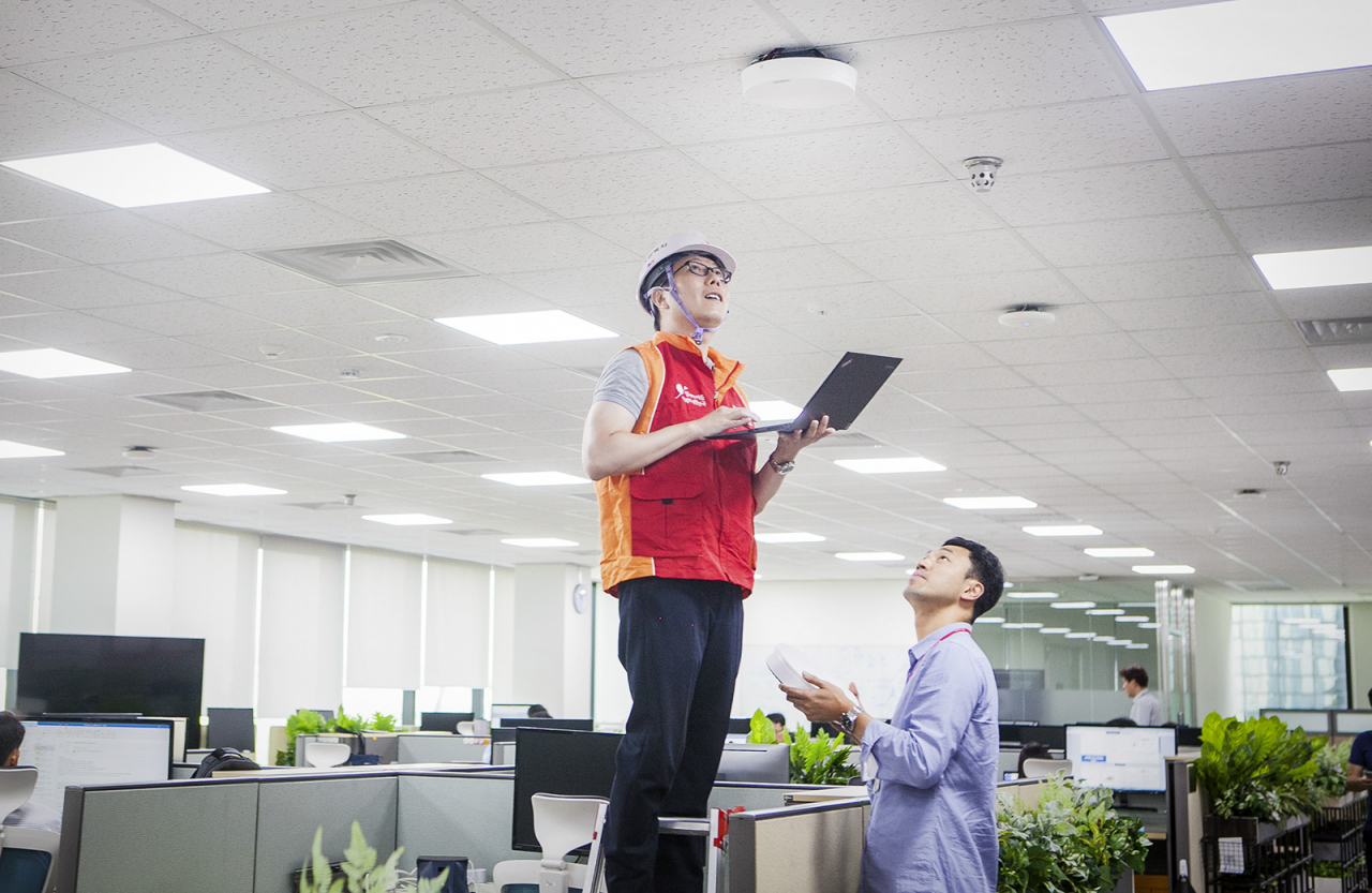 SK텔레콤 직원들이 SK텔레콤 분당사옥 5G 기지국에 '5GX 인빌딩 솔루션’을 적용해 최종 성능 검증을 하고 있다. [SK텔레콤 제공]
