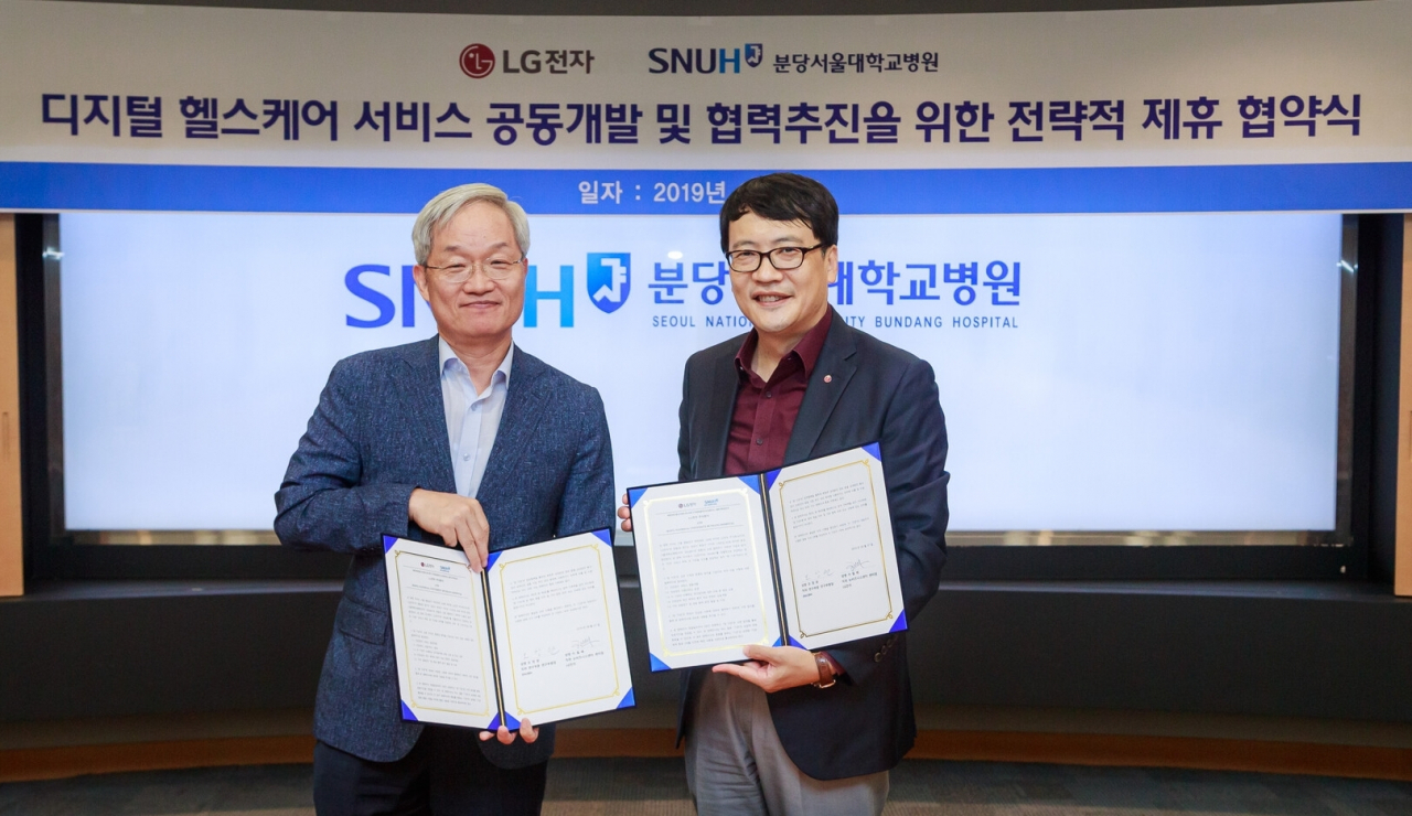 LG전자가 7일 경기 성남시에 위치한 분당서울대학교병원에서 디지털 헬스케어 서비스 공동개발 및 협력을 위한 양해각서(MOU)를 체결했다. 오창완 분당서울대병원 연구부원장(왼쪽), 이철배 LG전자 뉴비즈니스센터장(전무)이 기념촬영을 하고 있다.[LG전자 제공]