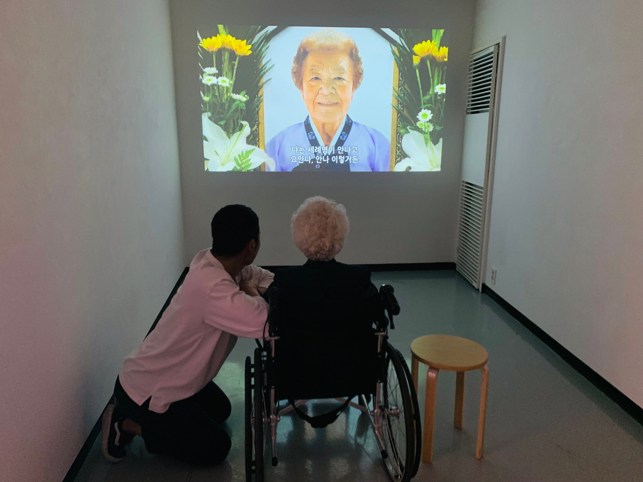 Lee watches a video of her late friend Kim Gun-ja, a former “comfort woman.” Kim, who stayed in a room next to Lee’s at the shelter, died in July 2017. Lee said Kim was like her “other half.” (Kim Arin/The Korea Herald)