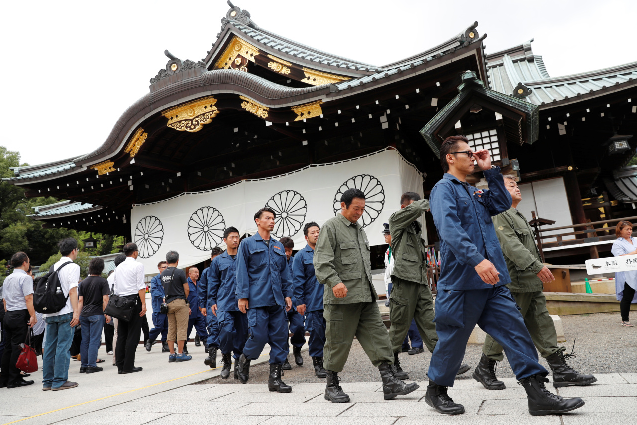 Right wing group members in uniform leave after paying tribute to the war dead at Yasukuni Shrine in Tokyo, Japan August 15, 2019, on the 74th anniversary of Japan's surrender in World War Two. (Reuters)