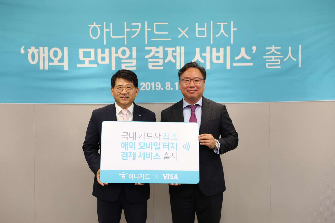 장경훈(왼쪽) 하나카드 사장이 14일 서울 중구 소공로에 있는 비자코리아 본사에서 ‘하나카드 x 비자 해외 모바일 결제 서비스’ 출시를 기념해 패트릭 윤 비자코리아 사장과 기념촬영을 하고 있다. [하나카드 제공]　