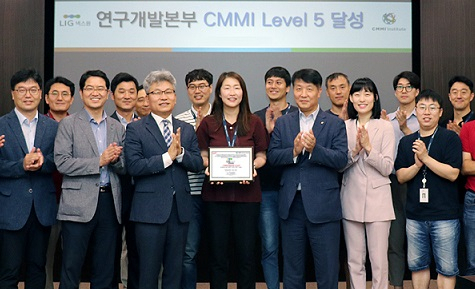 LIG넥스원 임직원들이 판교R&D센터에서 CMMI 레벨5 인증서를 들고 기념촬영을 하고 있다. [LIG넥스원 제공]