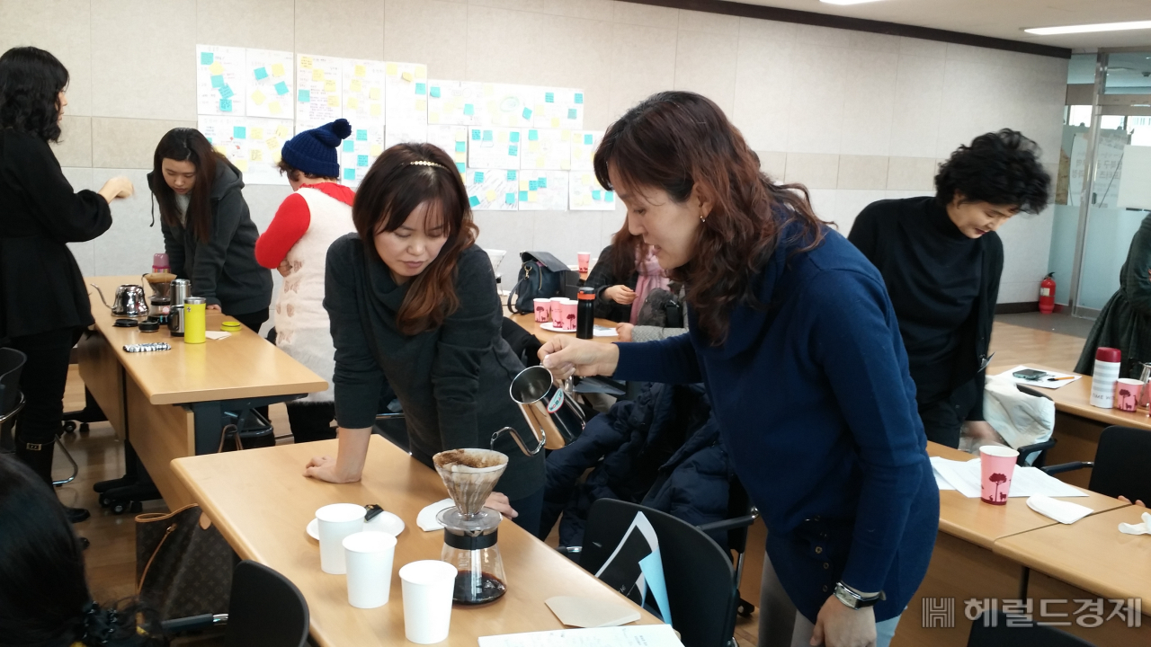 2018년 성북구에서 운영한 공정무역 시민서포터즈 양성교육에서 공정무역 커피를 활용한 핸드드립 체험 교육에서 한 참가자가 강의를 듣고 실습해보고 있다. [성북구]