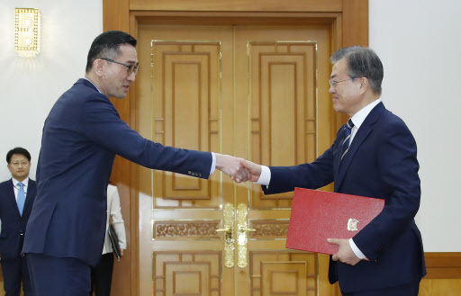 South Korean President Moon Jae-in (right) shakes hands with Eric Teo Boon Hee, Singapore's new ambassador to Seoul, at Cheong Wa Dae in Seoul on Wednesday. (Yonhap)