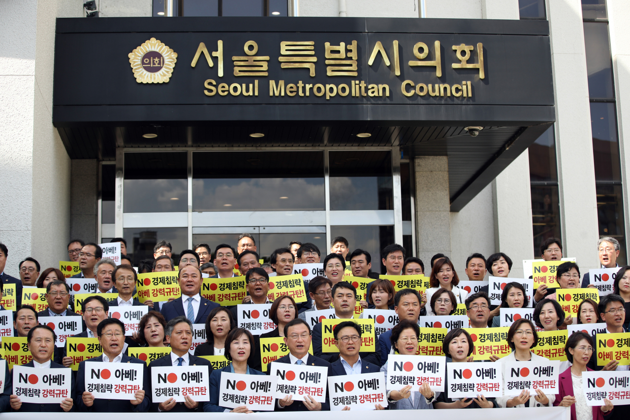23일 오후 서울시의회 앞에서 서울시의회 의원들이 일본 정부의 경제 침략 행위를 규탄하며 손팻말을 들고 있다. [연합뉴스]