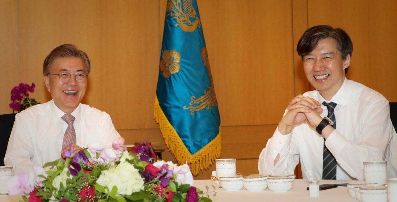 President Moon (left) and then-Senior Secretary to the President for Civil Affairs and Justice Cho Kuk are photographed together on May 11, 2017. (Cheong Wa Dae Joint Press Corps)