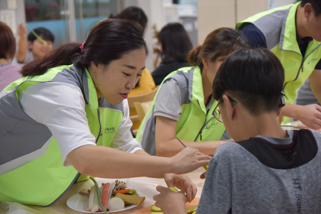 4일 건설공제조합 봉사단원이 삼성농아원을 찾아 명절음식만들기를 하고 있다. [건설공제조합 제공]