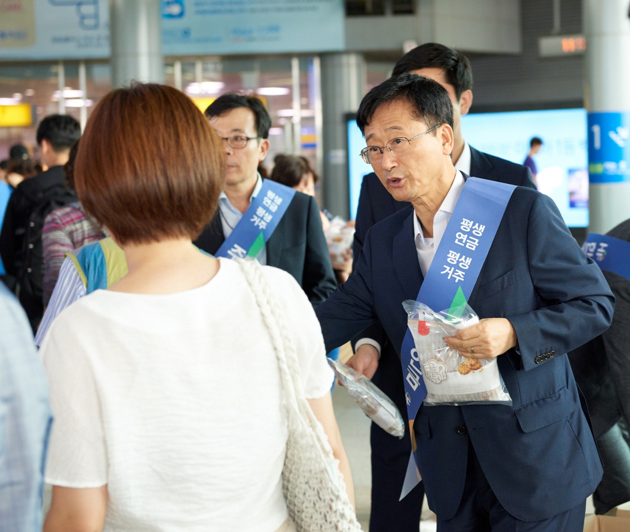 이정환 주택금융공사 사장이 귀성객에게 11일 부산역에서 명절 인사를 건네며 주택연금 홍보물과 선물을 전달하고 있다.