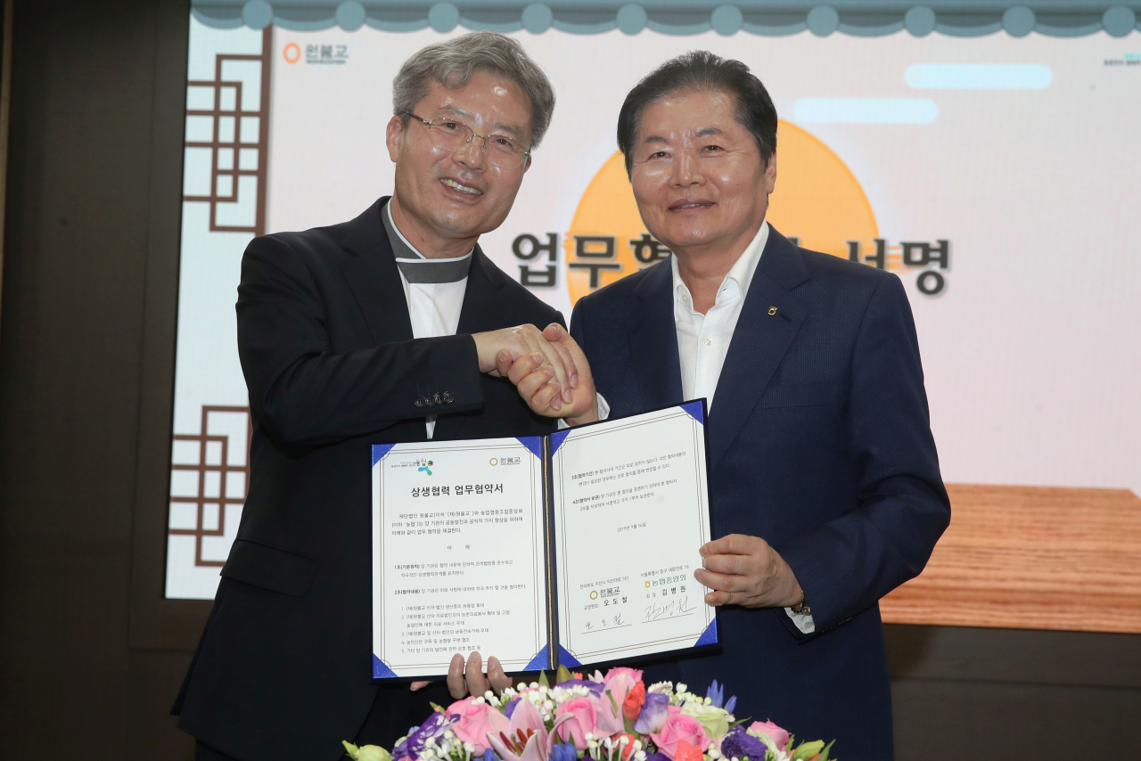김병원(오른쪽) 농협중앙회장이 오도철 원불교 교정원장과 상생협력 업무협약을 체결한 뒤 악수하고 있다. [농협 제공]