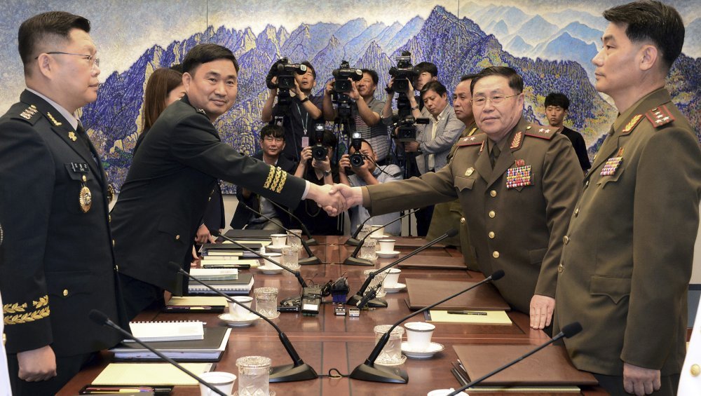 North Korean Lt. Gen. An Ik San (second right) shakes hands with his South Korean counterpart Maj. Gen. Kim Do-gyun during a meeting inside the Peace House at the border village of Panmunjom, South Korea, on July 31, 2018. (AP-Yonhap)