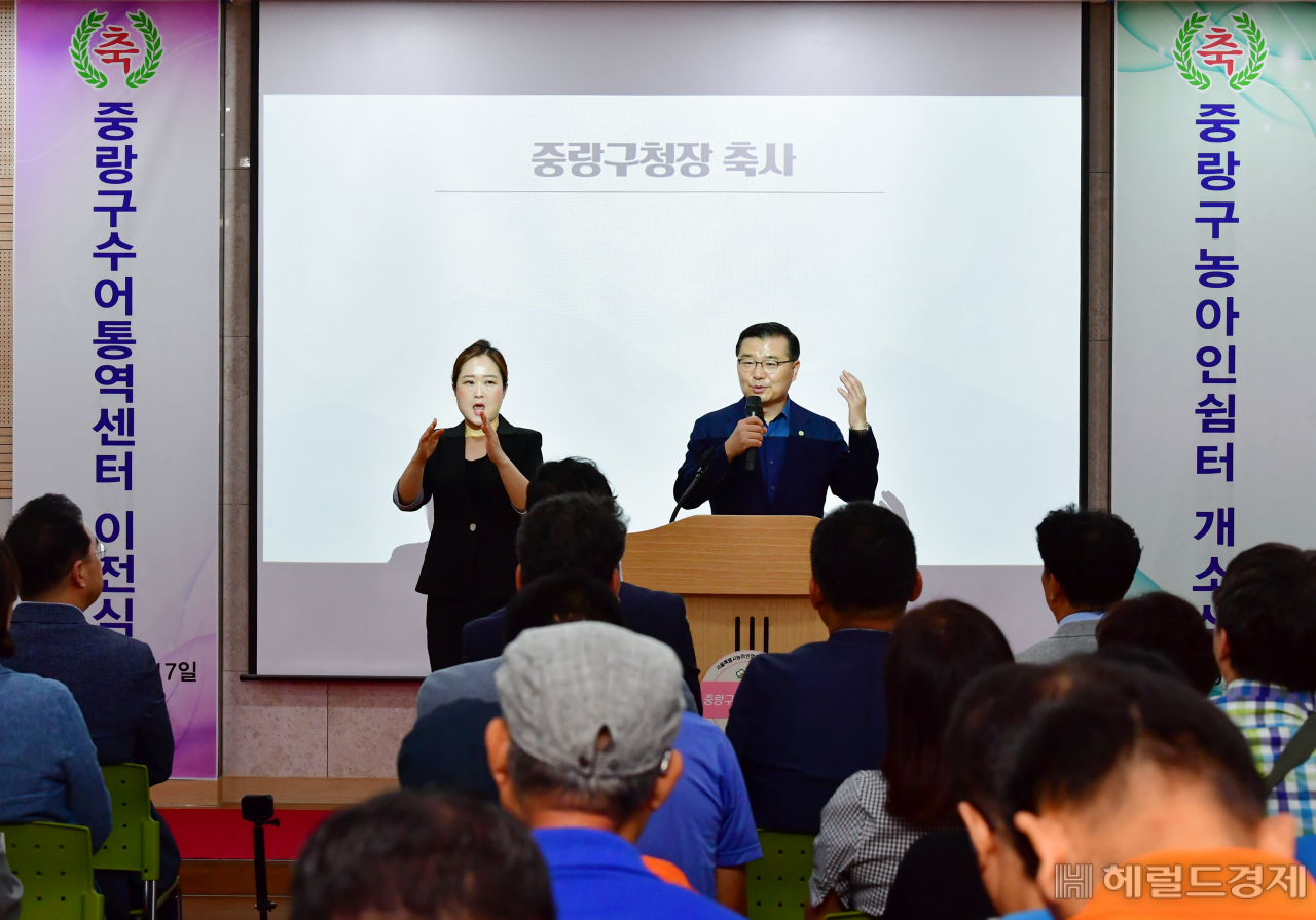 류경기(오른쪽) 서울 중랑구청장이 지난 17일 중랑구수어센터, 농아인쉼터 개관식에 참석해 “중랑구수어통역센터와 농아인쉼터가 우리구 농아인들의 소통과 정보공유의 소중한 공간으로 새롭게 단장되어 매우 기쁘게 생각한다” 말하고 있다. [중랑구]