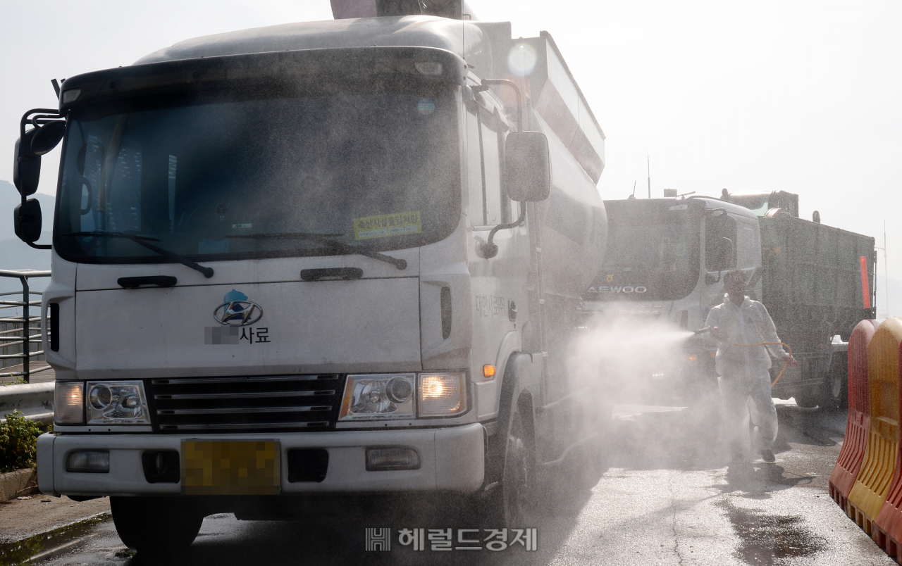 [헤럴드경제=박해묵 기자] 파주, 연천, 김포에 이어 강화에도 아프리카돼지열병(ASF)이 지난 24일 발생했다. 25일 오전 인천 강화군 강화대교에 위치한 ASF 의심농장 거점소독시설에서 강화를 왕래하는 차량 방역을 하고 있다.