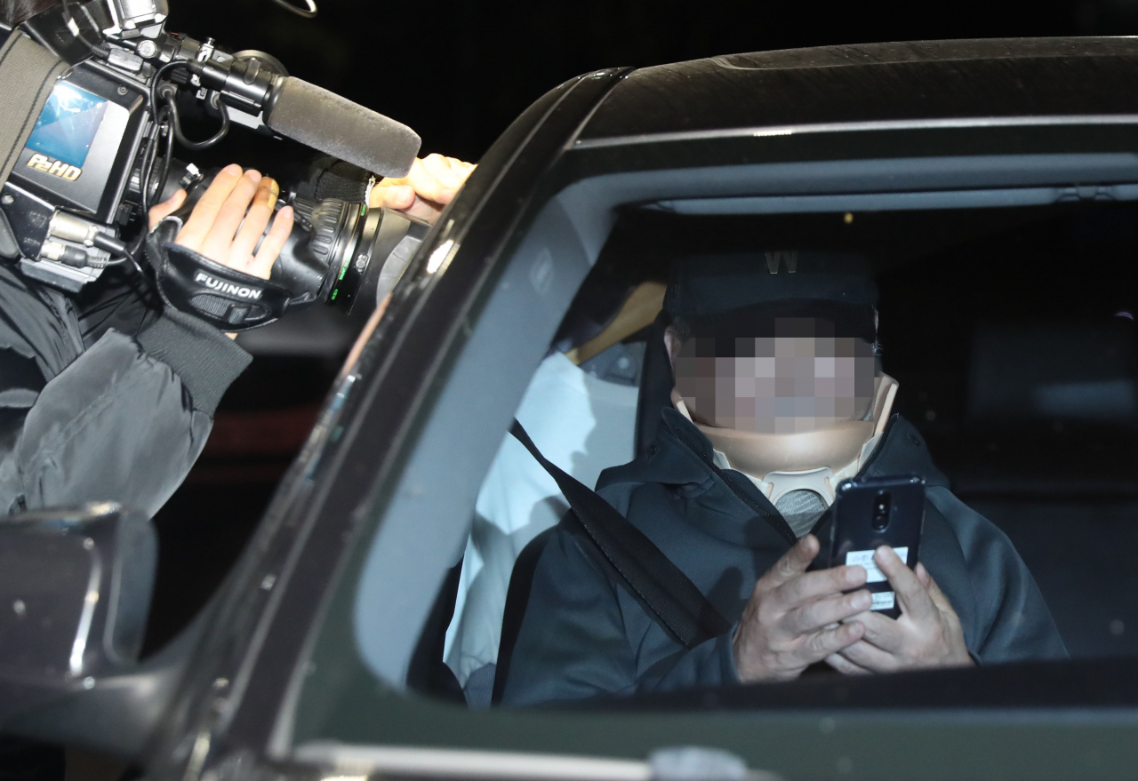 조국 법무부 장관의 남동생 조모 씨가 9일 오전 구속영장이 기각되자 대기하고 있던 승용차에 올라 의왕시 서울구치소를 나서고 있다. 여유롭게 스마트폰을 들여다보는 모습이 이채롭다 [연합]